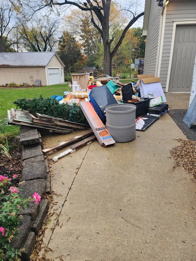 Dumpster being loaded with debris for Residential Dumpster Rental in Shawano